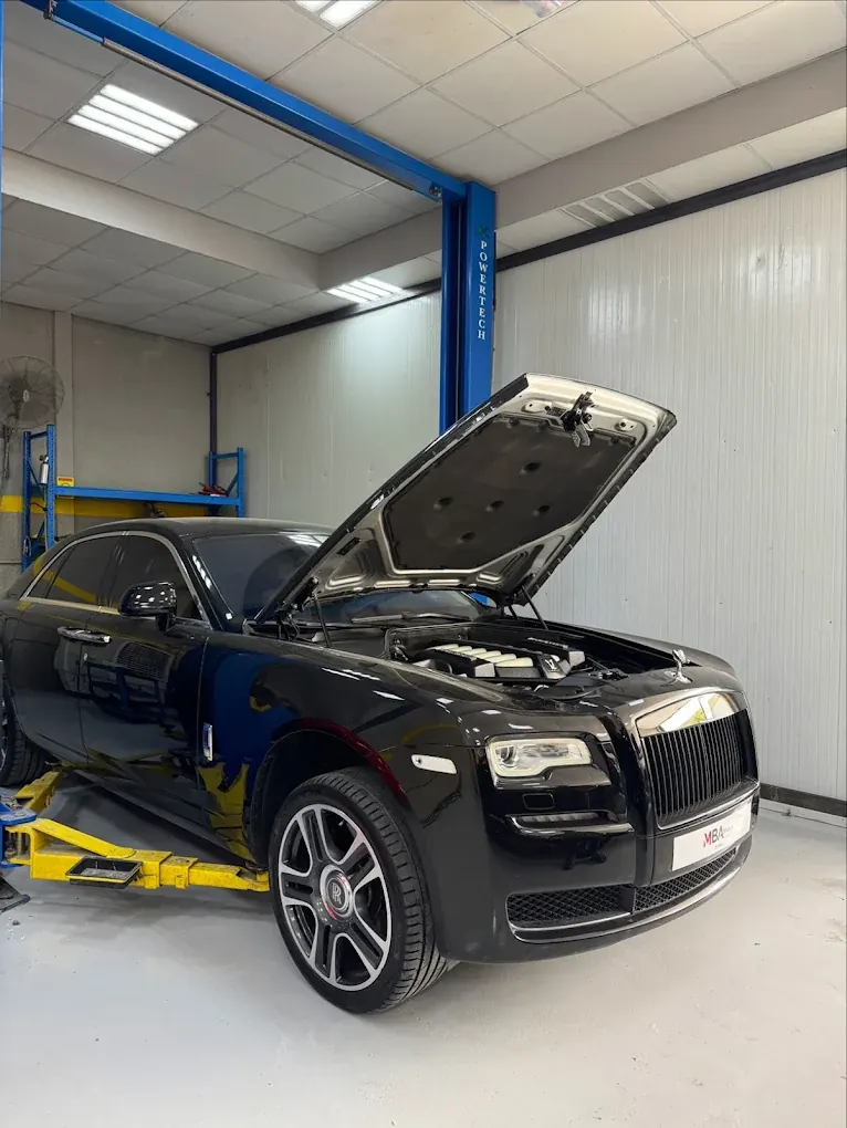 Rolls-Royce Ghost with bonnet open for engine bay service at Madeena Al Amwaj Auto Workshop