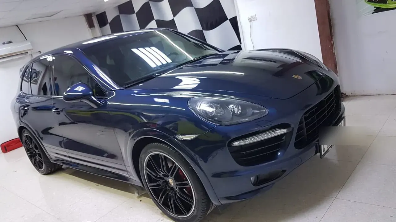Dark blue Porsche Cayenne serviced at Madeena Al Amwaj Auto Workshop